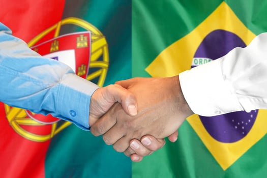 handshake on Portugal and Brazil flag background. photo