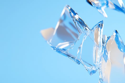 Shattered glass fragments, blue background, abstract design, website banner photo