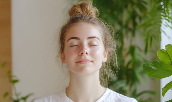 Woman meditating, plants background, home, serenity photo