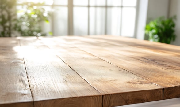Sunny wooden table, bright room, plants. Product display photo
