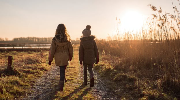 Two girls walking on a path in the countryside photo