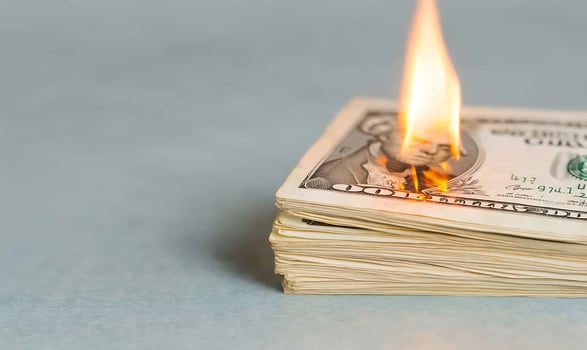 Burning money stack, loss concept, gray background photo