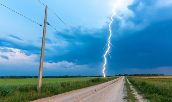 Lightning strike over rural road, storm clouds photo