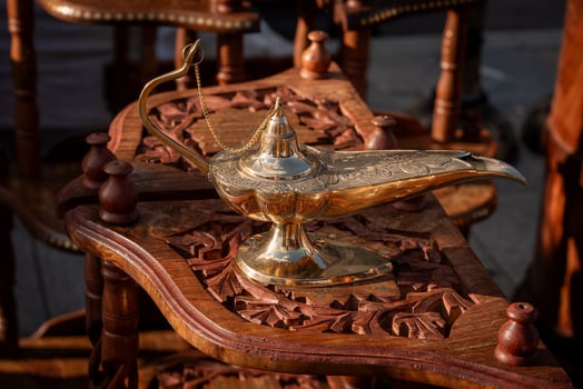 Ornate Brass Oil Lamp on Intricate Wooden Table photo