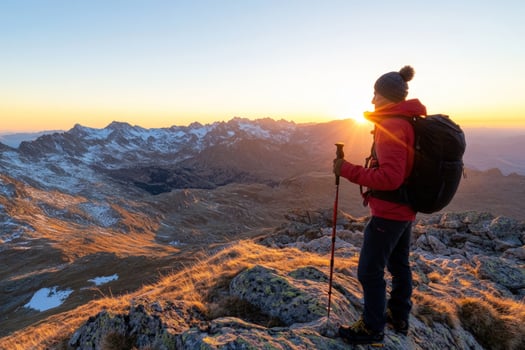 Person hiking in mountain landscape at sunset backpacking trekking outdoor adventure photo