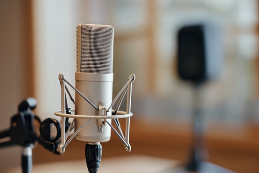Close-up of a professional microphone in a recording studio setting, highlighting its sleek design. photo