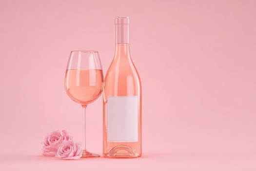 A glass of rose wine sits beside a bottle on a soft pink background, accompanied by two delicate pink roses, evoking a romantic and inviting atmosphere perfect for celebrations. photo
