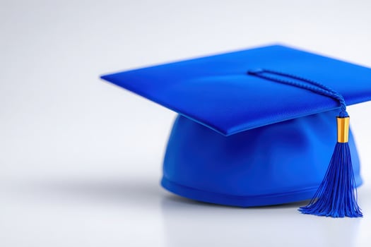 A vibrant blue graduation cap featuring a golden tassel is centered against a neutral backdrop. The focus highlights the significance of graduation ceremonies and academic achievements. photo
