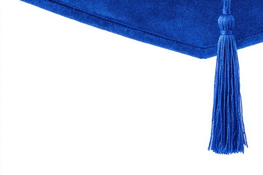 A vibrant blue graduation cap is displayed against a plain background, showcasing a detailed tassel that signifies achievement and the excitement of graduation day. photo