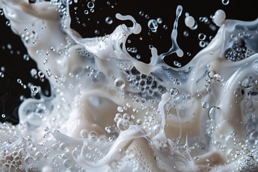 Dynamic splash of milk with bubbles creating a lively and textured visual on a dark background. photo