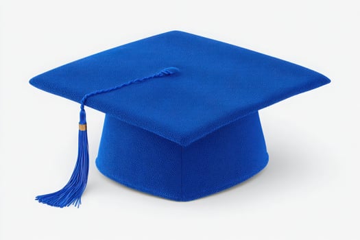 A vibrant blue graduation cap resting on a light background showcases the traditional headwear worn during graduation ceremonies, symbolizing accomplishment and success in education. photo