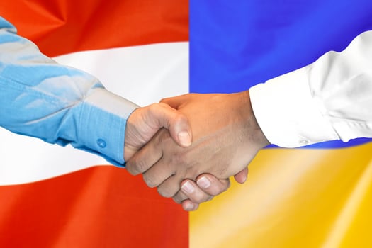 handshake on Austria and Ukraine flag background. photo