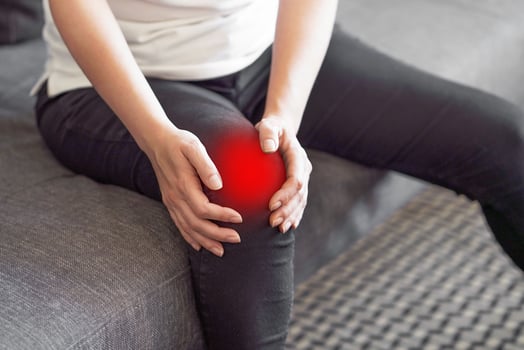 Woman Feeling Joint Pain, Having Health Issues And Touching Leg With Hands. photo