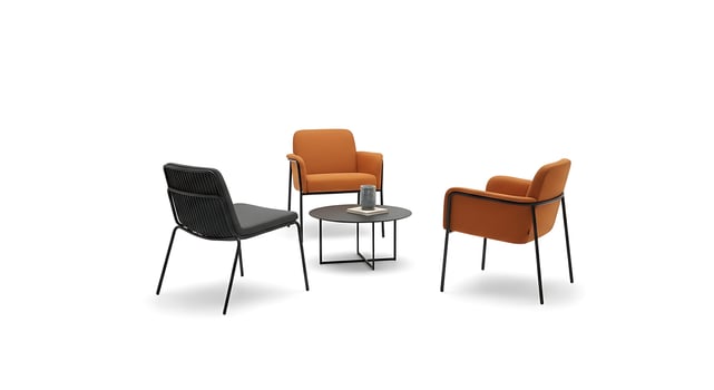 Three chairs and a table with an orange chair photo