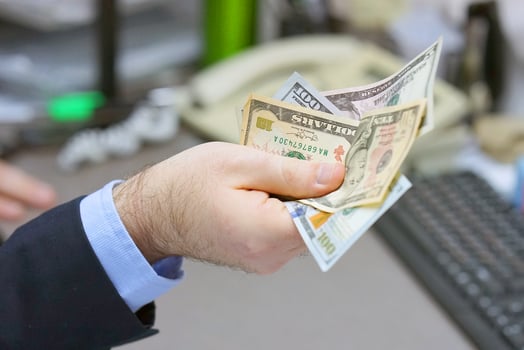Businessman gives a bribe in office photo
