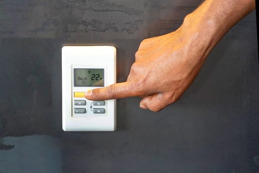 black hand man turns on air conditioning photo