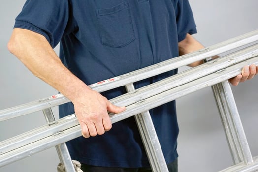 European worker man with aluminum ladder photo