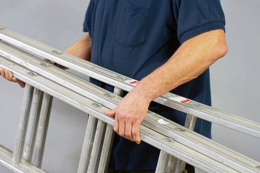 Caucasian worker man with aluminum ladder photo
