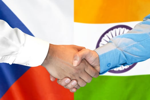 handshake on Czech Republic and India flag background. photo