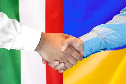 handshake on Italy and Ukraine flag background. photo