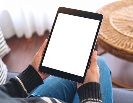 Woman using tablet with blank screen photo