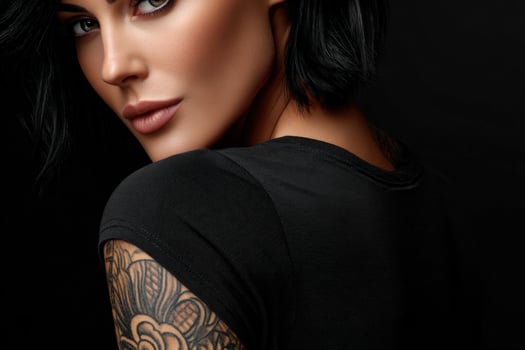 A beautiful woman with tattoos on her arms photo