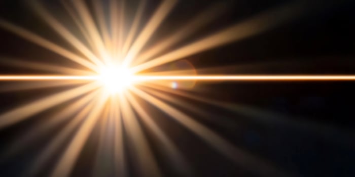 Bright sun rays burst, dark background, lens flare, abstract design photo