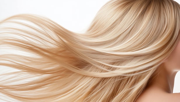 Blonde womans flowing hair, studio shot, beauty, haircare photo