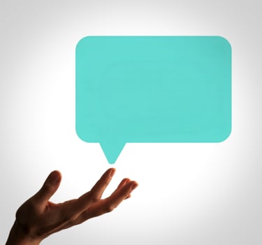 Hand holding a speech bubble on a white background photo