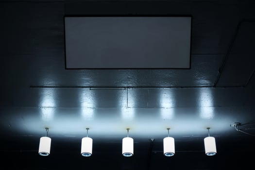 A ceiling with lights and a white board photo