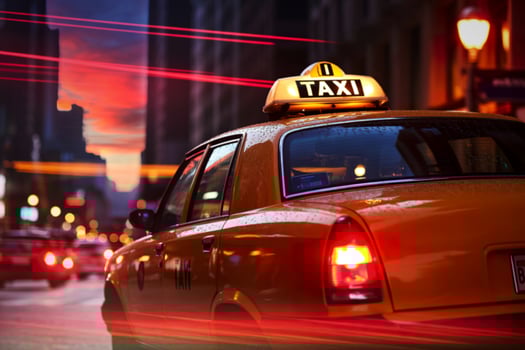 Yellow taxi cab at sunset in city traffic photo