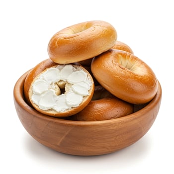 Rustic Wooden Bowl with Bagels and Cream Cheese on White Background, High Detail. photo