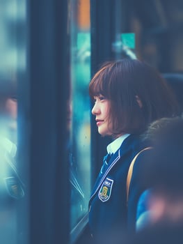 Pensive Young Woman Gazing Out Bus Window on a Rainy Day. photo