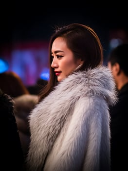 Elegant Woman in a Luxurious Fur Coat, Side Profile. photo