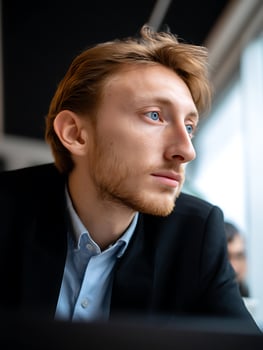 Close Up Portrait of a Young Man with Blue Eyes, Pensive Expression. photo