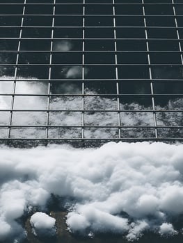 Snowdrift Partially Covering a Metal Grid Pattern. photo