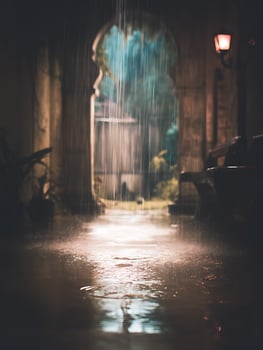 Rainy Night Scene A Pathway Through an Archway in the Rain. photo