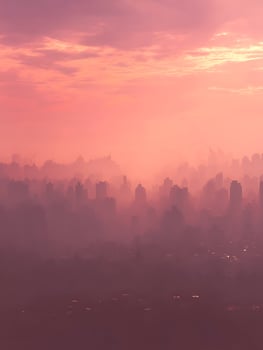 Pink Cityscape at Sunrise A hazy, atmospheric view of a city skyline bathed in the soft light of dawn. photo
