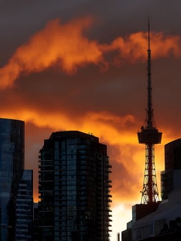 Fiery Sunset Silhouette of City Buildings and Tower. photo