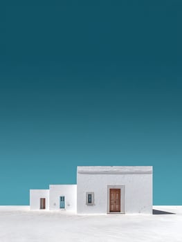 Minimalist White Houses Under a Vibrant Teal Sky A Stunning Architectural Image. photo