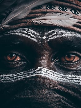 Close Up of a Person's Eyes with Traditional Tribal Paint and Feathers. photo