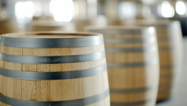 Oak barrels in warehouse, aging process, blurry background, industrial setting, stock photo