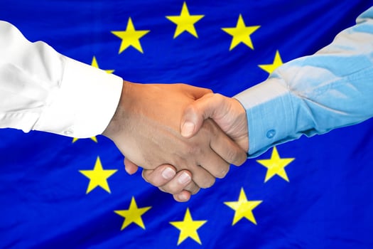 handshake on European Union flag background photo