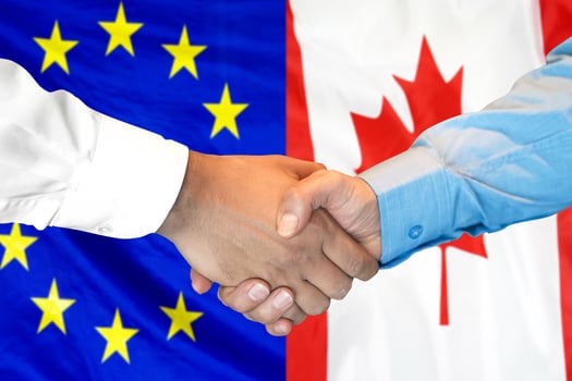 handshake on European Union and Canada flag background photo