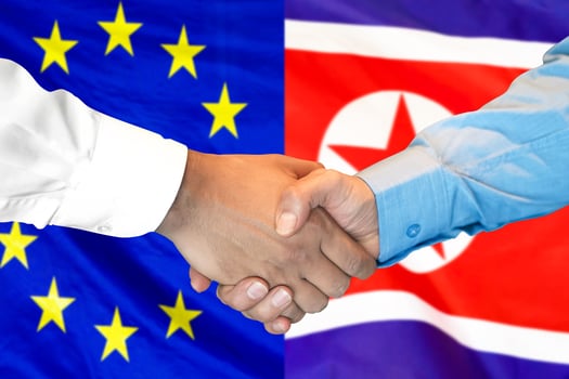 handshake on European Union and North Korea flag background. photo