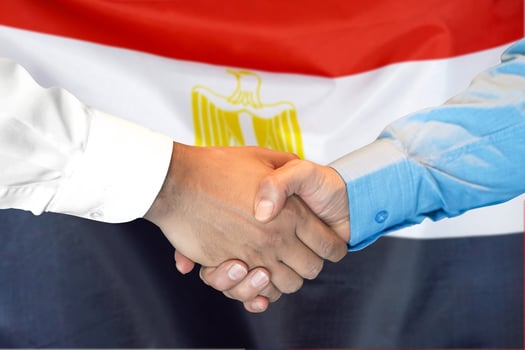 handshake on Egypt flag background. photo