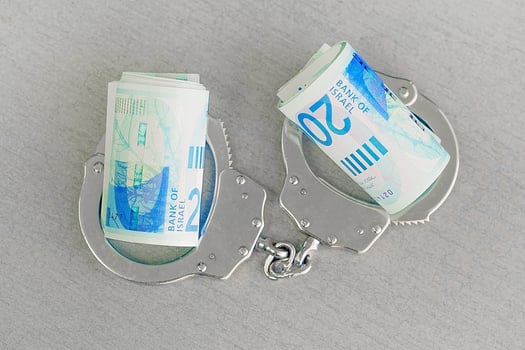 Handcuffs on and twisted money on the table photo