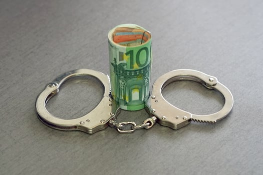 handcuffs on and twisted money. Top view. photo