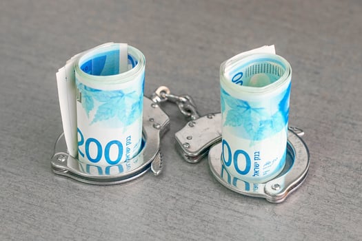 Handcuffs on and twisted money photo