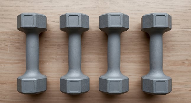 Gray dumbbells on wooden surface photo